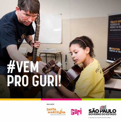 Card do projeto Guri. Nele há uma foto de um professor, de camiseta azul, de pé, segurando um violão com uma das mãos e auxiliando uma aluna sentada, também segurando um violão. Na arte há um texto escrito "#vemproguri" e os logotipos da Santa Marcelina, do projeto Guri e do Govberno do Estado de São Paulo.