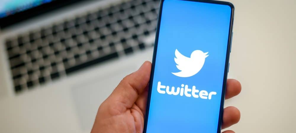 Mão segurando um celular com o logo do Twitter, para ilustrar o prejuízo da empresa.