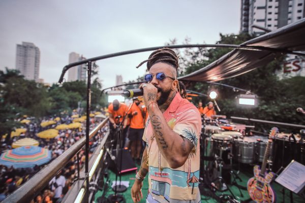 rapper rael em cima de trio elétrico cantando segurando microfone próximo à boca. rael fará show no sesc em são josé dos campos.