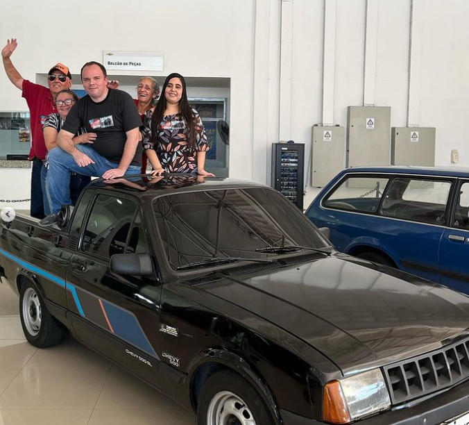 A Chevy 500 na cor preta de Luiz Felipe Kuschausky; ele e a família comemoram em cima do carro a vitória no concurso Possante Novo
