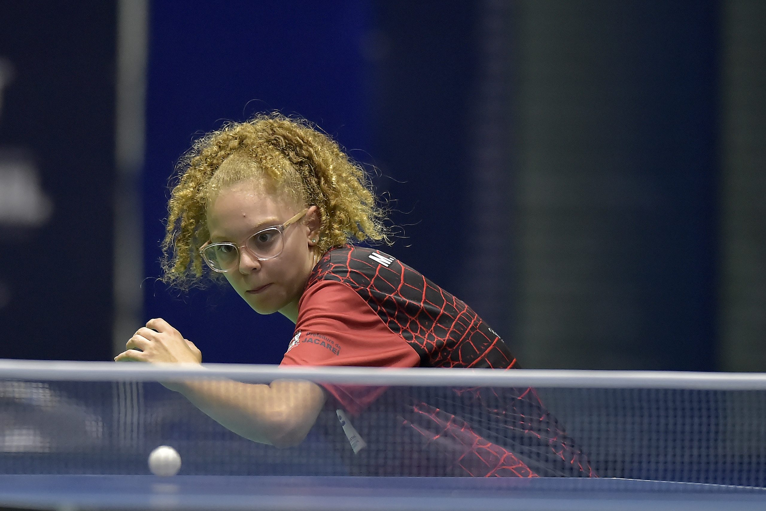 Maria, jovem de Jacareí, jogando partida de Tênis de Mesa e se preparando para atacar a bola