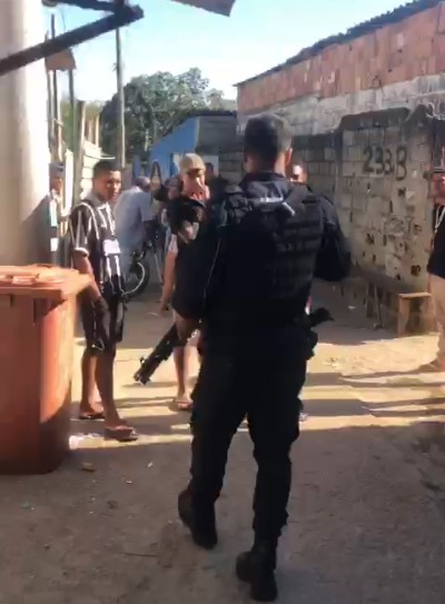 Guarda Civil Municipal (GCM) em frente aos moradores do Banhado, com arma na mão
