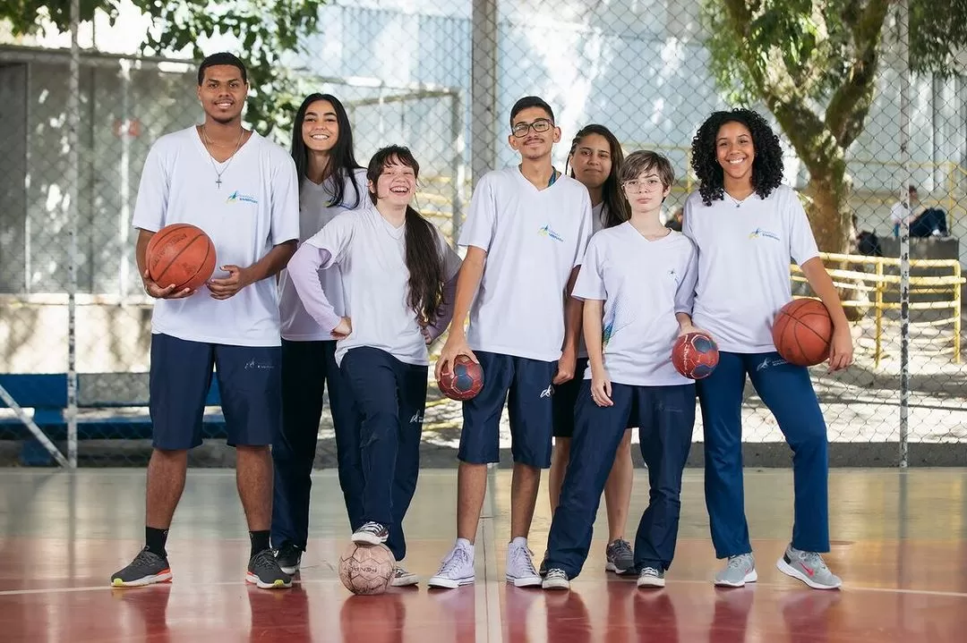 Alunos do colégio Embraer, reunidos em quadra com bolas de basquete nas mãos; inscrições para processo seletivo com vagas no Ensimo Médio estão abertas em SJC